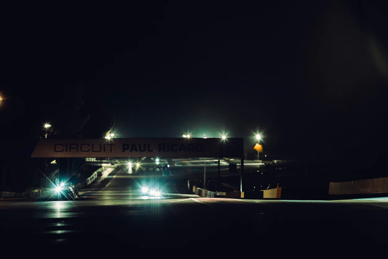 Circuit Paul Ricard illuminated at night with motorcycle racing in the distance